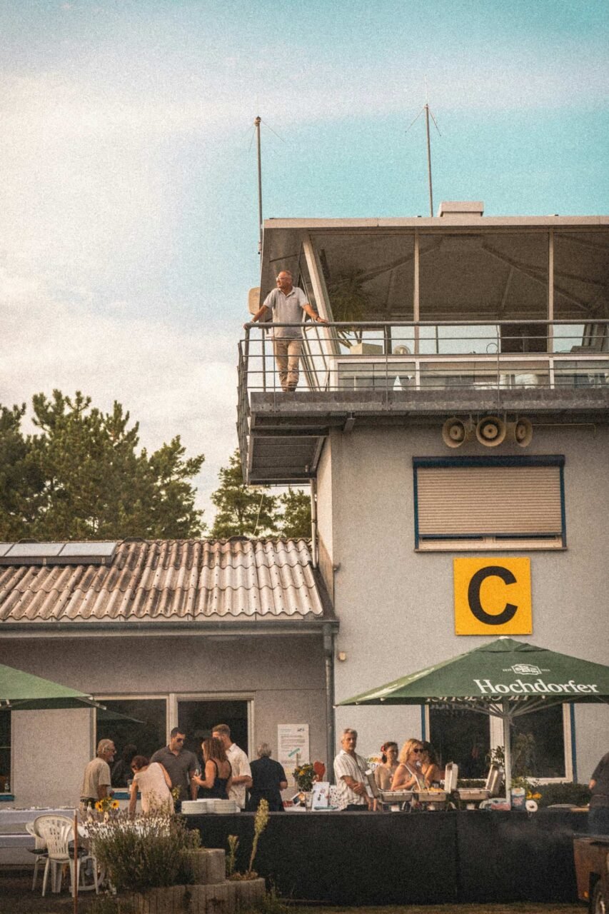 A group of people sitting outside of a building